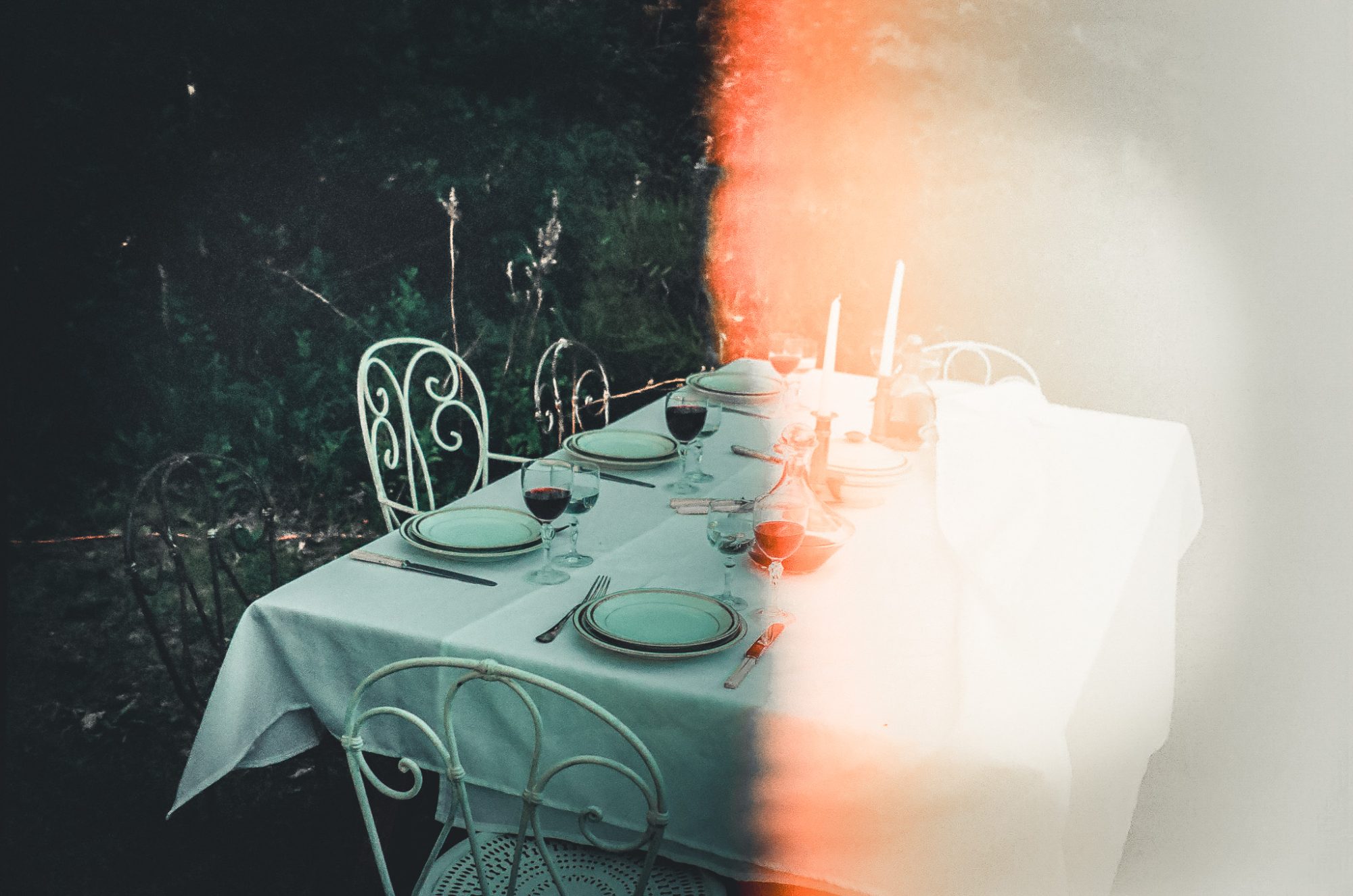 The lunch table under the trees, half of the frame burnt out by light